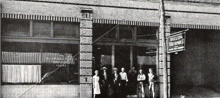Historic storefront with people standing outside.